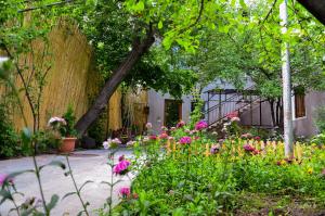 a garden with pink flowers and a fence at Narek B&B in Goris