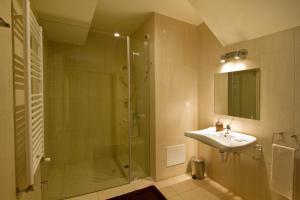 a bathroom with a glass shower and a sink at Quinta de Lograssol in Mealhada +38 photos