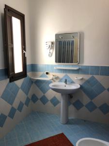 a bathroom with a sink and a mirror at DAMMUSI JERIMAR in Lampedusa