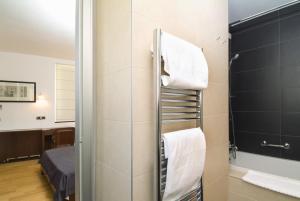 a bathroom with a shower with white towels at Hotel Vestibul Palace & Villa - Small Luxury Hotels Of The World in Split