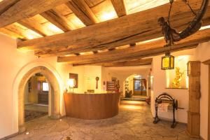 a large room with a wooden ceiling with beams at Hotel Goldenes Roessl-adults only in Bressanone