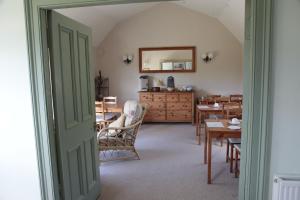 a dining room with a table and a mirror at Dunchraigaig House in Kilmartin