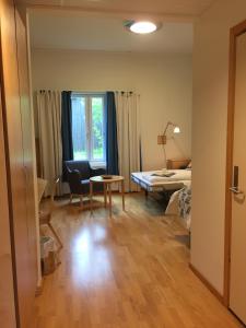 a room with a bed and a desk and a table at Unicare Røros in Røros