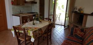 a kitchen with a table with chairs and a table and a tableablish at Stella fiorita in Panicarola