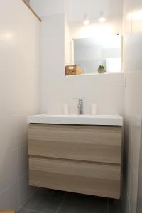 a bathroom with a sink and a mirror at Résidence La Corvette in Toulon +15 photos