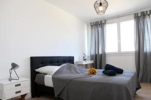 a bedroom with a bed and a lamp and windows at Résidence La Corvette in Toulon