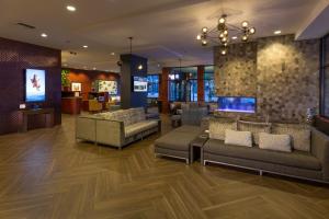 a lobby with couches and a tv in a building at Silver Cloud Hotel - Seattle Stadium in Seattle