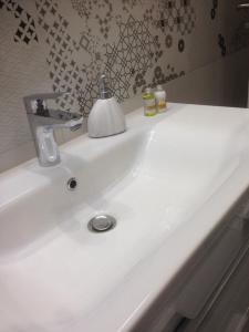 a white bathroom sink with a soap dispenser on it at Villa Maria in Zadar