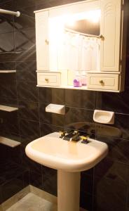 a bathroom with a white sink and a mirror at Lo de Viviana in San Salvador de Jujuy +20 photos