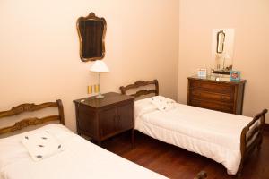 a room with two beds and a dresser in it at Lo de Viviana in San Salvador de Jujuy