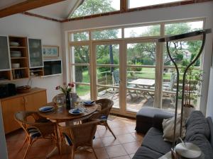 a living room with a table and a couch at Sonnendeck in Wustrow