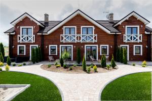 a house with a garden in front of it at Przy Rozlewisku in Sarbinowo