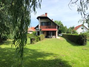 a house with a green yard in front of it at Mária Villa in Balatonmáriafürdő