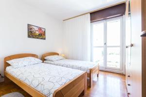 Postel nebo postele na pokoji v ubytování Nina Apartment