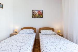 Postel nebo postele na pokoji v ubytování Nina Apartment