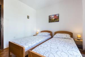 Postel nebo postele na pokoji v ubytování Nina Apartment