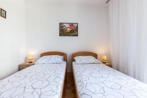 Postel nebo postele na pokoji v ubytování Nina Apartment
