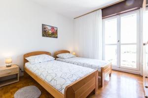 Postel nebo postele na pokoji v ubytování Nina Apartment