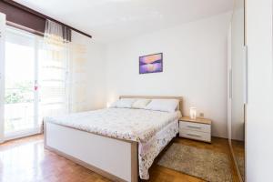 Postel nebo postele na pokoji v ubytování Nina Apartment