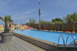 a large swimming pool with a wooden deck at Sas Robrecht in Saint-Tropez