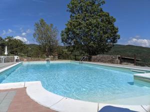 una gran piscina de agua azul en Casa Vacanze Fattoria il Cerro en Pianelleto