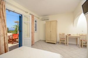 a room with a door open to a dining room at Orkos Blue Coast in Mikri Vigla +33 photos
