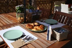 a wooden table with a plate of food on it at Il Gatto Stanco B&B in Arona