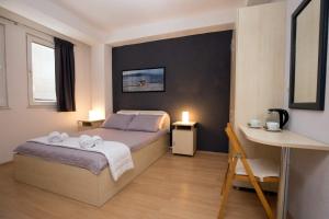 Ένα ή περισσότερα κρεβάτια σε δωμάτιο στο OZ Apartments +26 φωτογραφίες