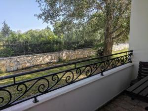 a balcony with a bench and a stone wall at Beni Bungalows in Ulcinj
