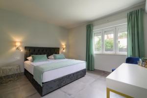 a bedroom with a large bed with green curtains at Villa Gala in Trogir +61 photos