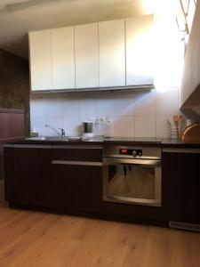 a kitchen with a sink and a stove top oven at Trakai Old town Apartment in Trakai