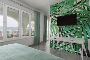 a bedroom with a bed and a flat screen tv at Villa Gala in Trogir