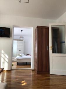 a room with a bedroom with a bed and a door at CASA ALISE-LUISE in Braşov