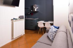 a living room with a couch and a table at Modena Charme Sant'Eufemia in Modena