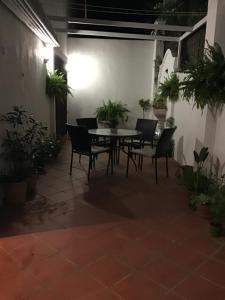a patio with a table and chairs and potted plants at Casares Village Bed & Breakfast in Casares