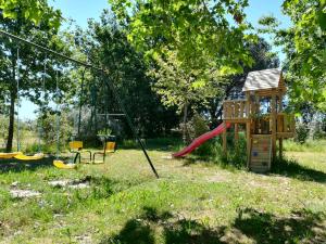 a playground with a slide and a swing at Casa Das Palmeiras-Pedagogic Farm in Mangualde +85 photos