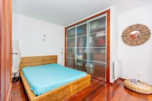 a bedroom with a bed and a large window at Cascais Seaside Home - 2 min away from the beach in Cascais