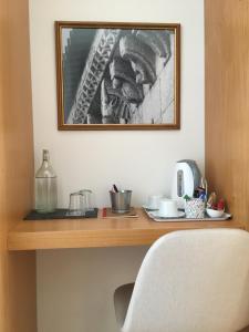 a wooden desk with a picture on the wall at Refúgio do Tâmega in Penafiel