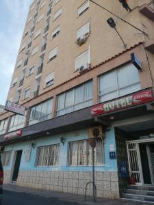 a building with a hotel on the side of the street at Hotel Alain in Silla