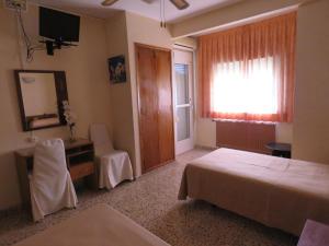 Postel nebo postele na pokoji v ubytování Hotel Alain