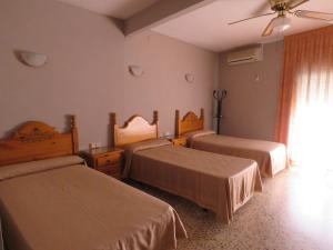 Postel nebo postele na pokoji v ubytování Hotel Alain
