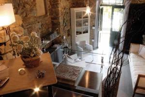 a living room with a table and a stone wall at Locanda Tramonti in La Spezia +15 photos