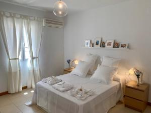 A bed or beds in a room at AYAMONTE Deluxe