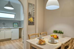 a kitchen and dining room with a table with food on it at Domus Claudia in Rome +18 photos