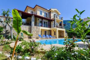 a villa with a swimming pool in a resort at Kilic- 5 Bedroom Holiday Villa in Hisaronu in Ovacik