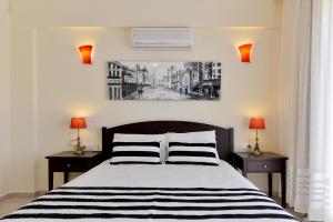 a bedroom with a black and white bed with two lamps at Kilic- 5 Bedroom Holiday Villa in Hisaronu in Ovacik +32 photos
