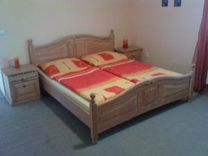 una camera con letto in legno e 2 comodini di Penzion Piano Ranch a Mladá Boleslav