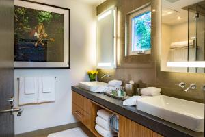 a bathroom with a sink and a large mirror at Sunset Marquis Hotel in Los Angeles