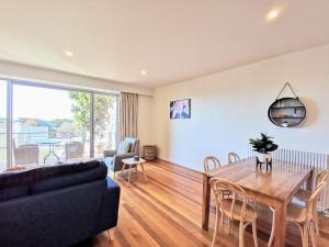 a living room with a table and a couch at Phoenix Apartments in Lorne