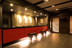 a bathroom with a red counter and two stools at Dormy Inn Premium Kyoto Ekimae Natural Hot Spring in Kyoto